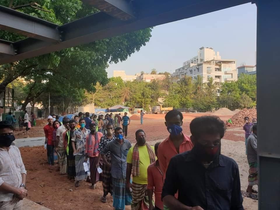 Community members gathered in an outdoor distribution area